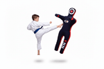 Child in white martial arts uniform kicking a black and red dummy labeled 'Ninja' on a white background