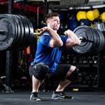 Person lifting a barbell in a gym setting